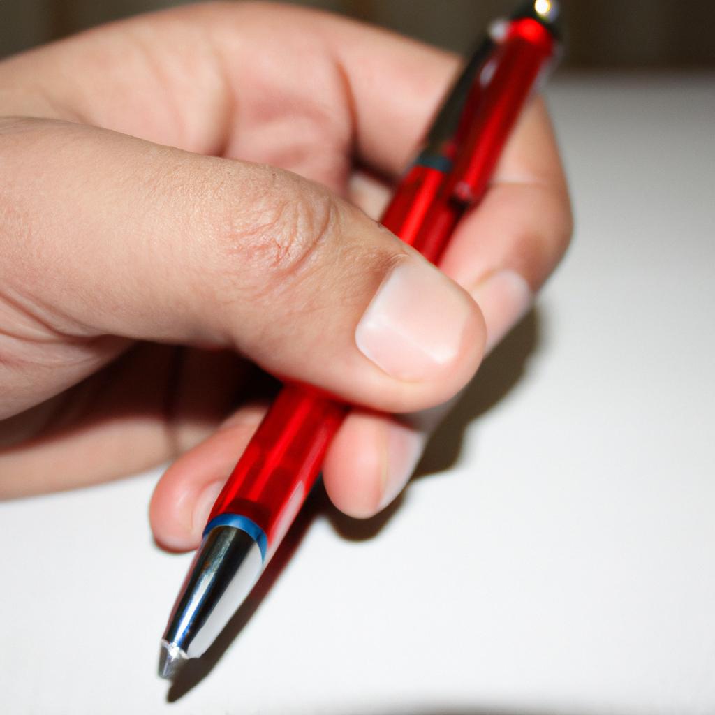 Person holding a red pen