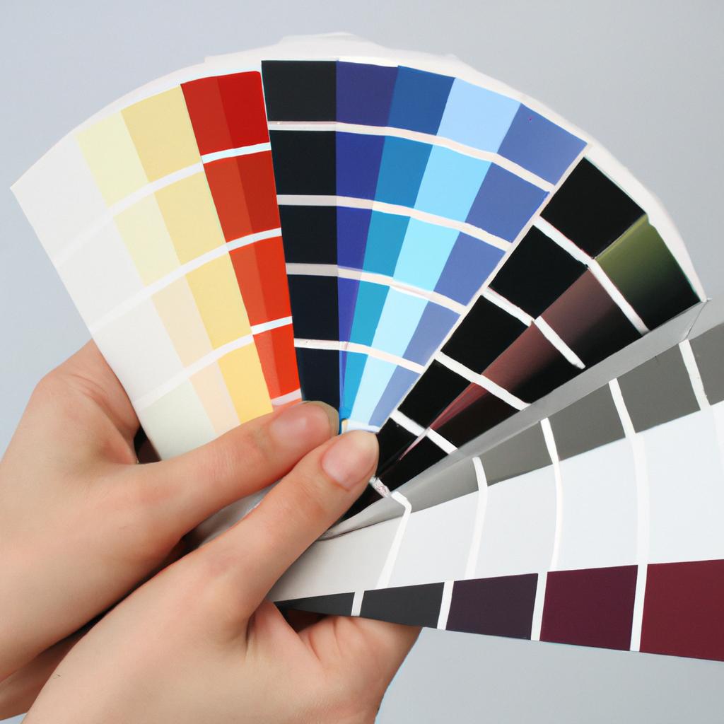 Person holding color swatches, designing